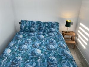 154LP Alhambra Park Home | Image of a bed with a blue cover